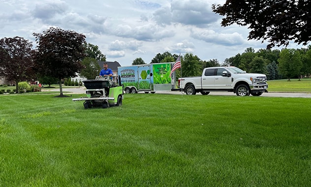 truck and lawn care in front of house